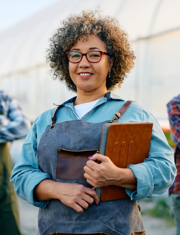 women holding books smiling at the camera