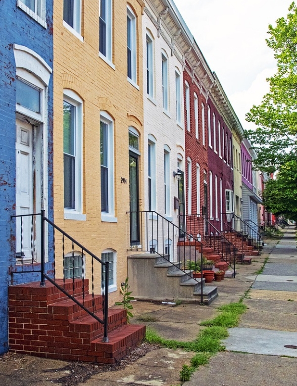 row of colorful townhouses along a street